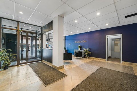 A hallway with a blue wall and a sign that says "Central at 12th".