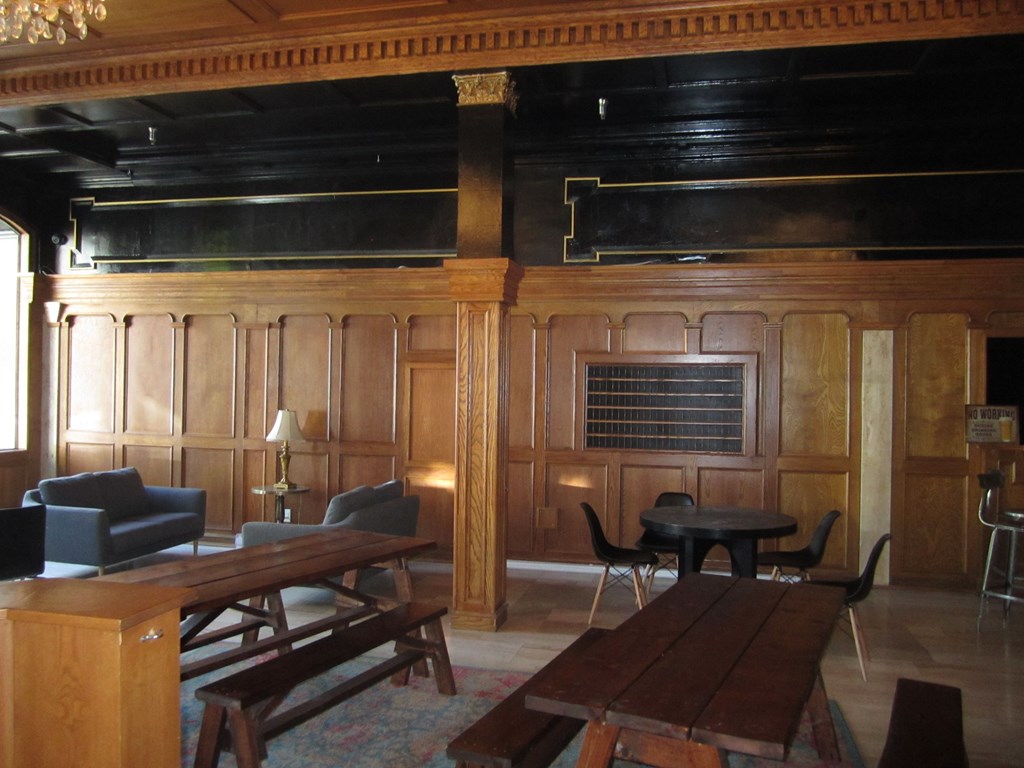 A room with wooden walls and a table in the middle.