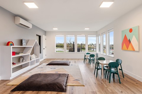 A room with a brown rug on the floor and a painting on the wall.
