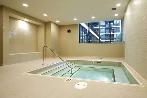 A small indoor pool with a glass divider.