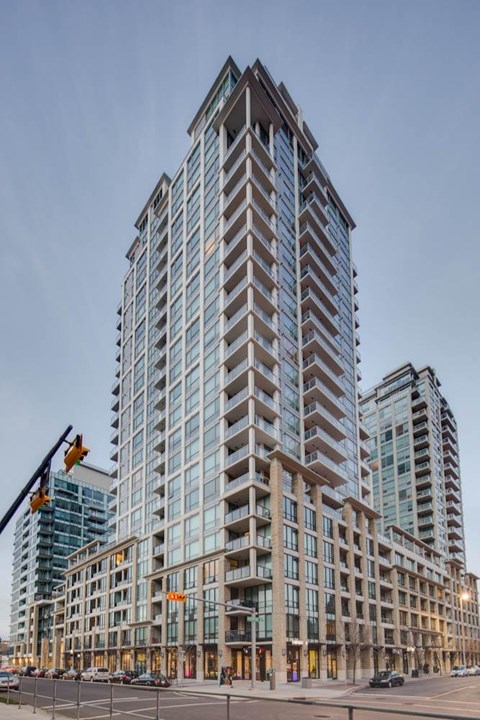 A modern glass building stands tall in the cityscape.