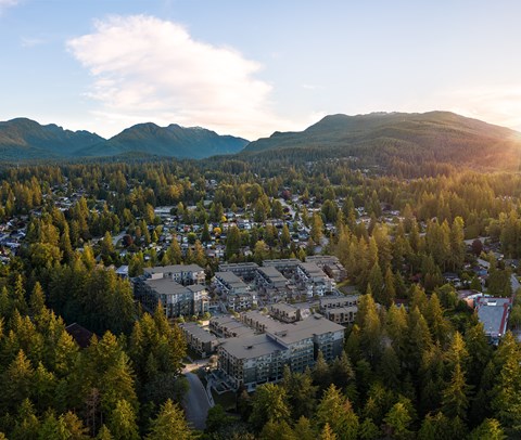 A small town surrounded by trees and mountains.