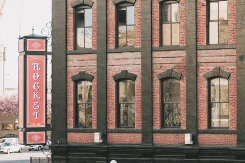 A red and white sign that says Rocket on the side of a building.
