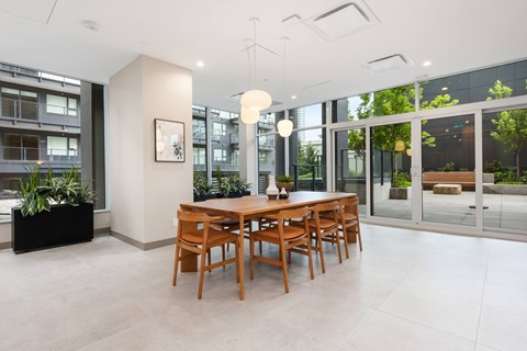 A dining room with a wooden table and chairs.
