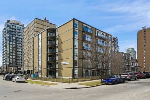 A multi-story building with the sign "SUNNY DAY" on the front.