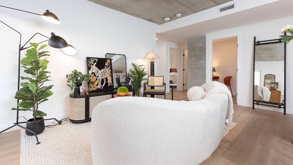 a living room with a white couch and a tv