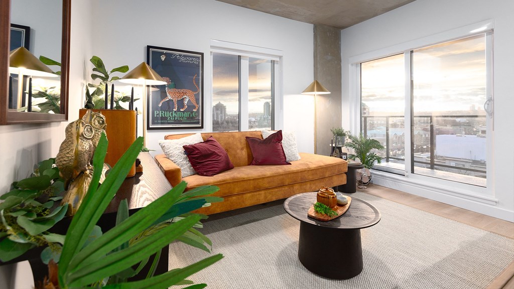 a living room with a yellow couch and a large window