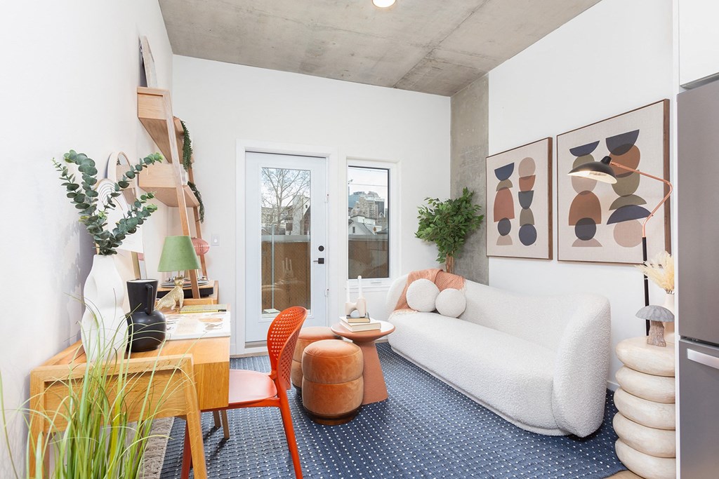 a living room with a white couch and a table with chairs