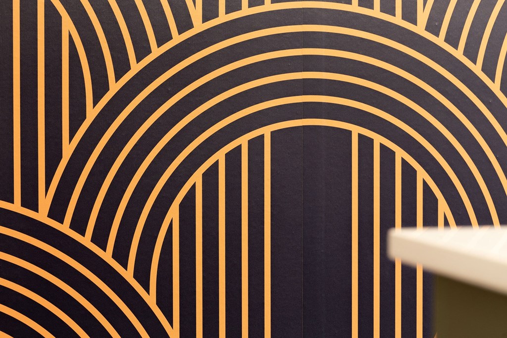 a close up of a black and gold design on a wall