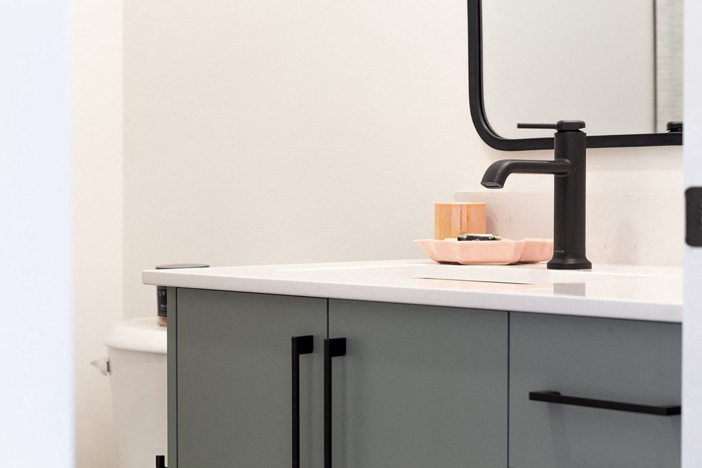 a bathroom with a sink and a black faucet