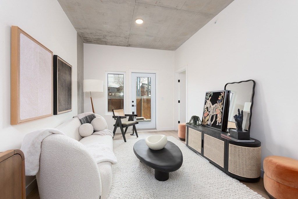 a living room with a white couch and a tv