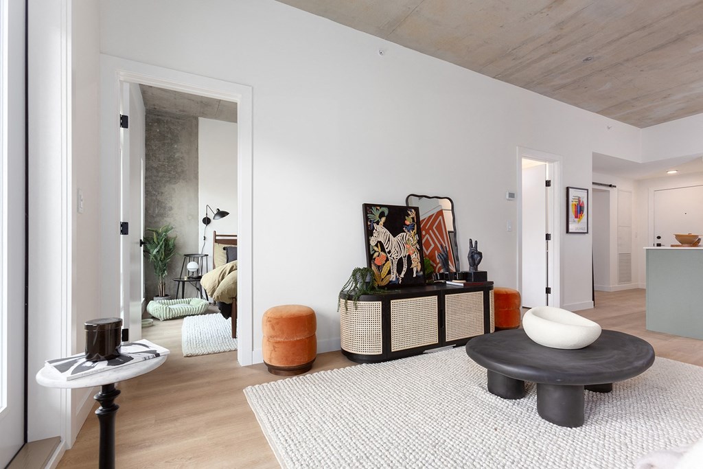 a living room with white walls and a white rug