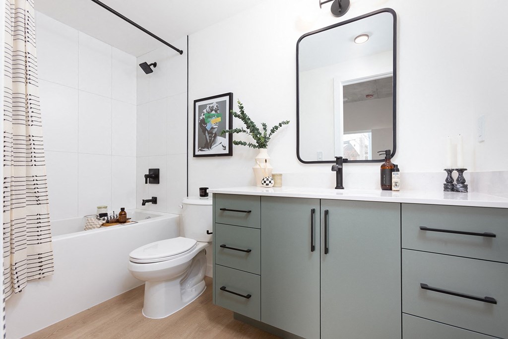 a bathroom with a sink and a toilet and a mirror