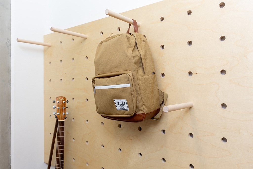 a backpack hangs on the wall of a climbing wall with the letters y and r