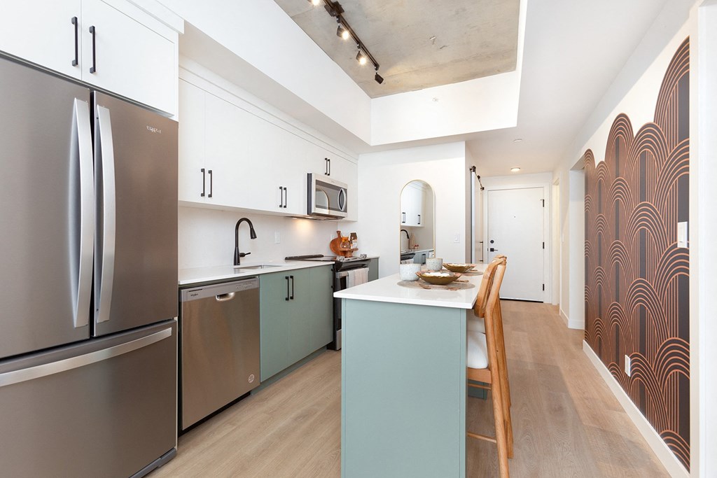 a kitchen with stainless steel appliances and a blue counter top