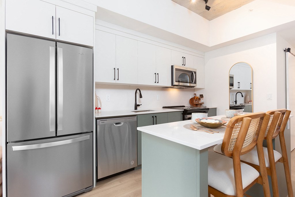 a kitchen with stainless steel appliances and a white counter top