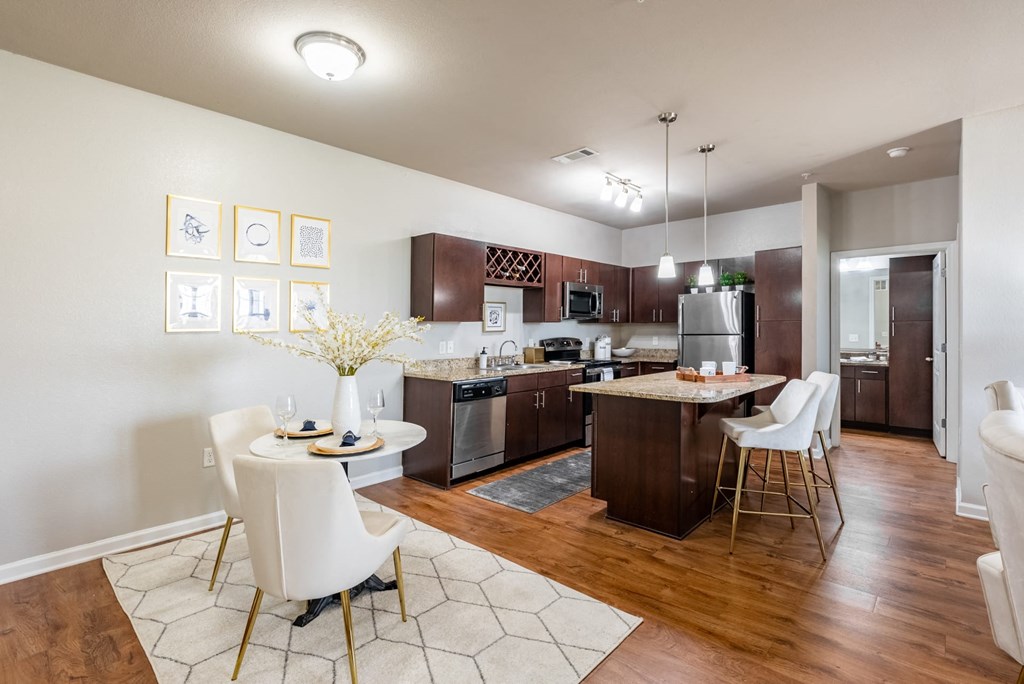 an open kitchen and dining room with a table and chairs