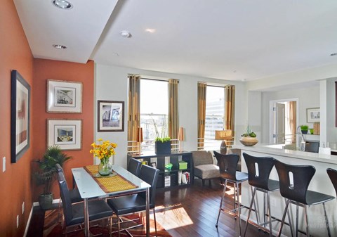 A dining room with a table set for six.