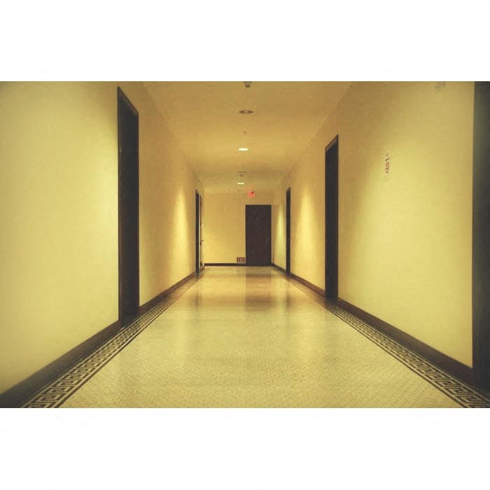 A long hallway with a light at the end.