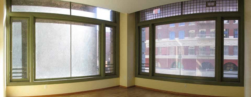 A room with a view of a building across the street.