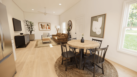 A modern dining room with a round table and chairs.