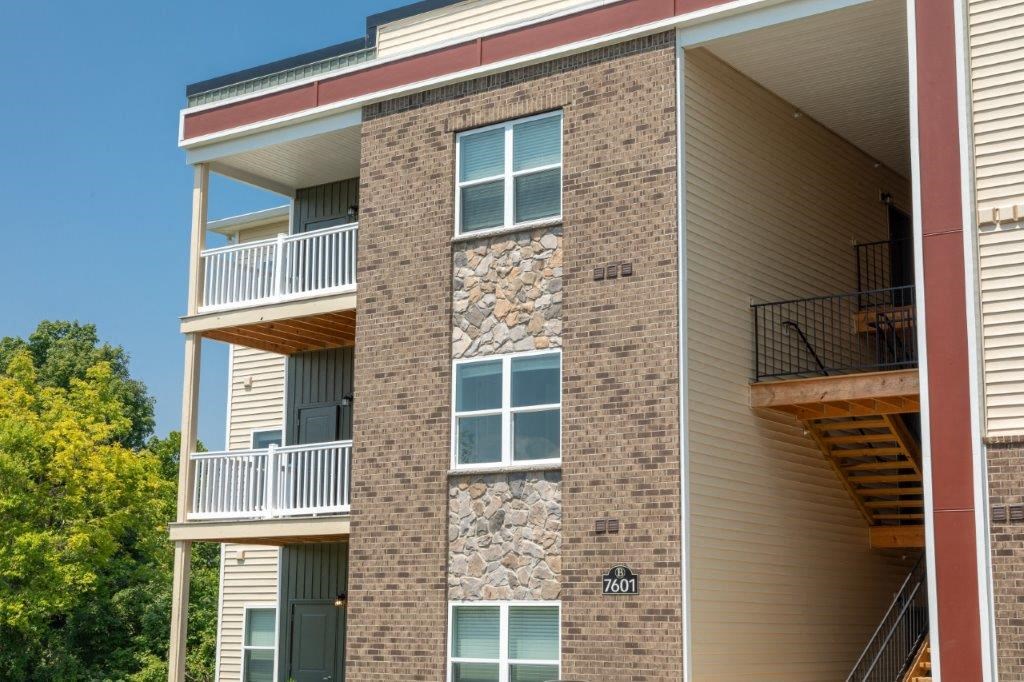 two pictures of a building with balconies and a tree