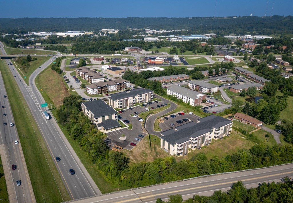 an aerial view of a city with buildings and a highway