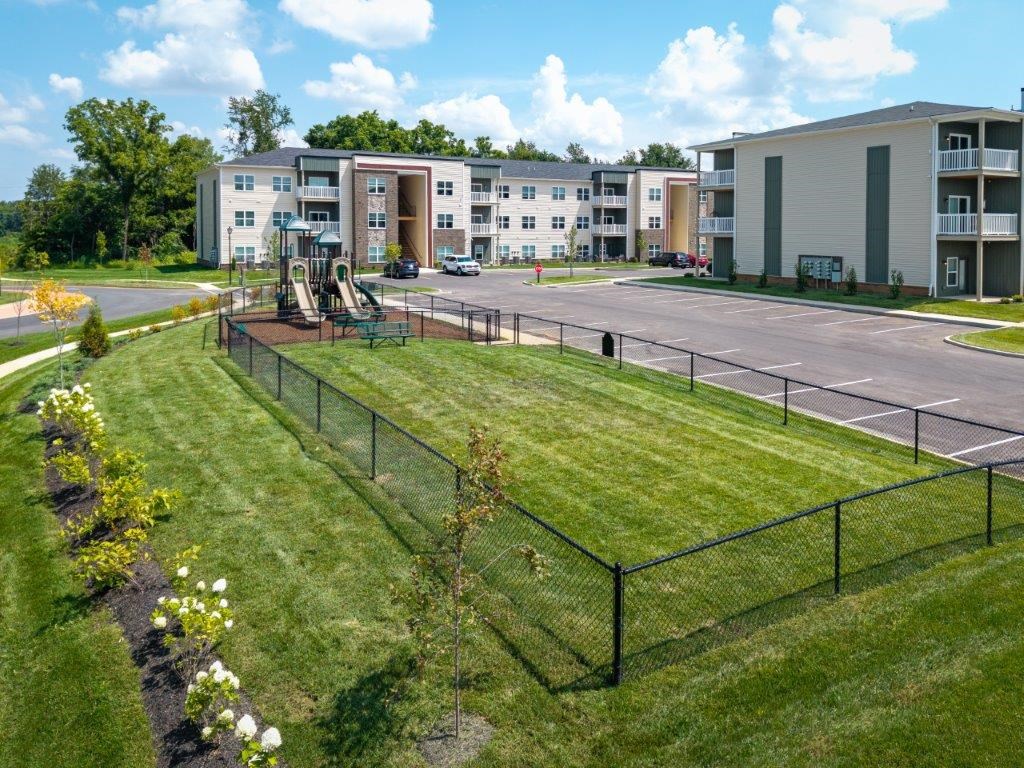 A view of apartment buildings with a playground in the foreground.