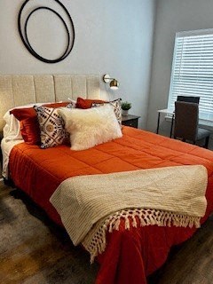 a bedroom with an orange and white bed