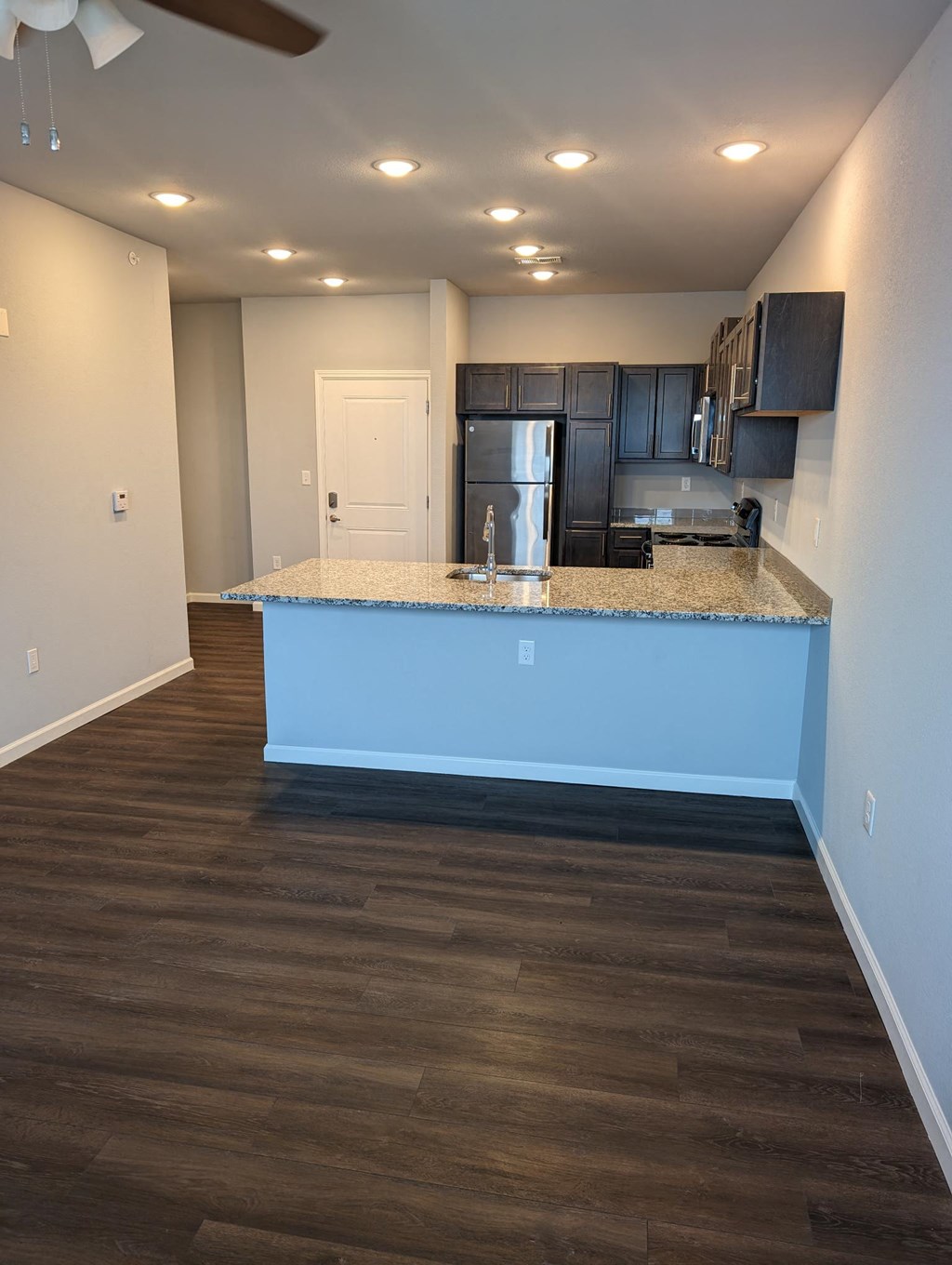 a kitchen with a blue counter top in a empty room