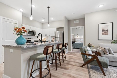 A kitchen with a bar area and a dining table.