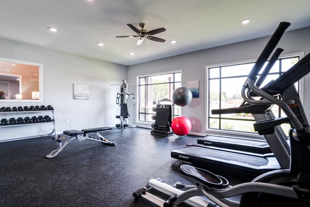 A spacious home gym with a variety of exercise equipment.