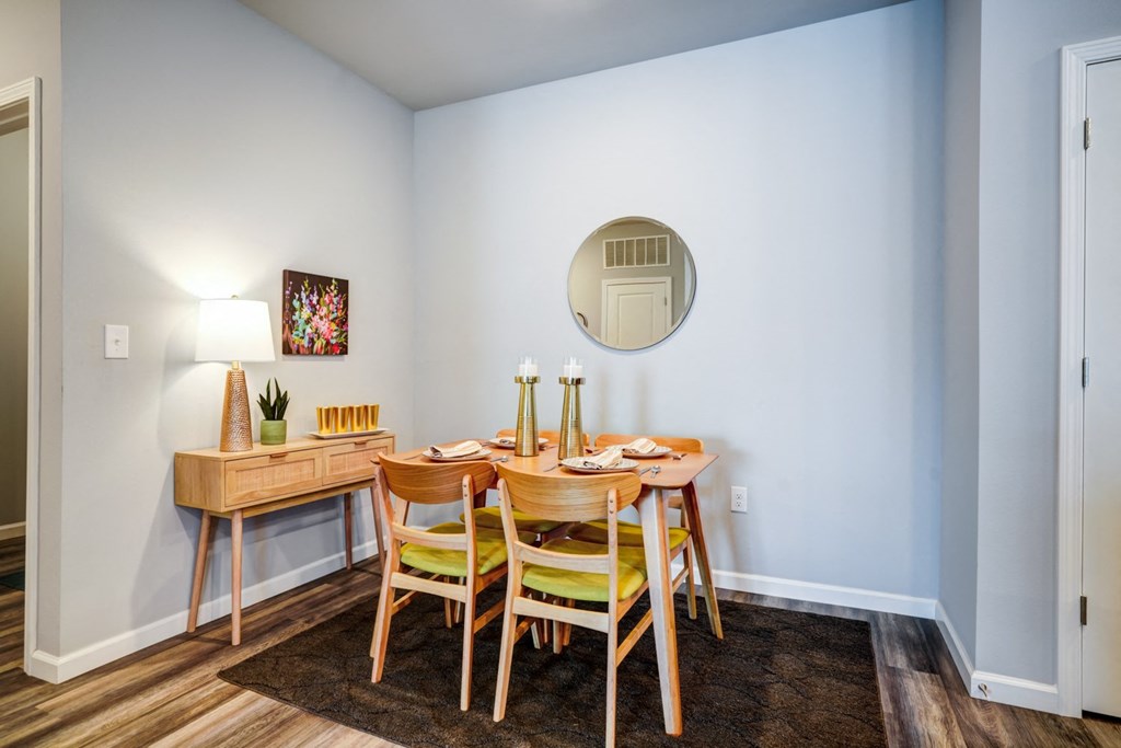 A dining room with a wooden table and chairs.