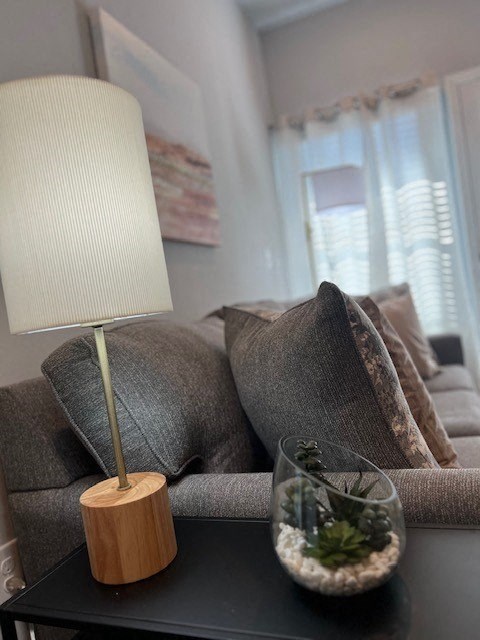 a living room with a couch and a lamp on a table