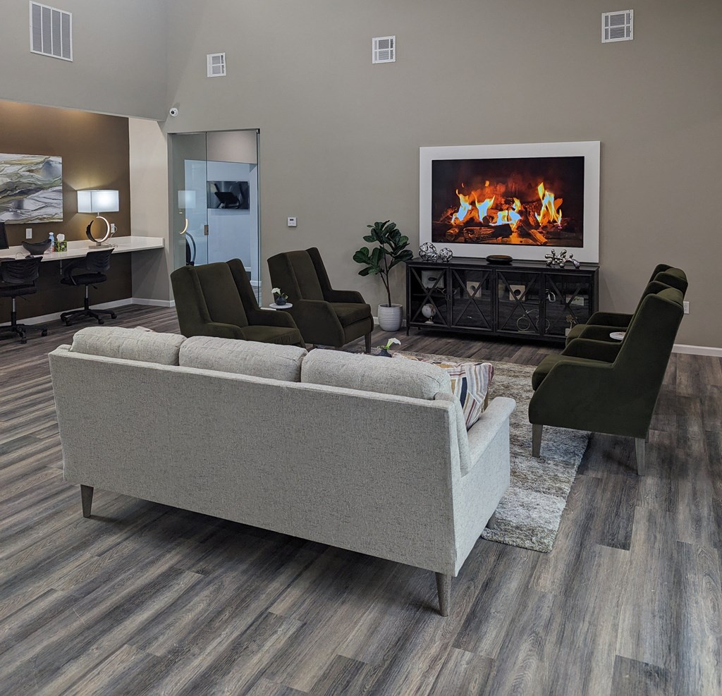 a living room with a fireplace and a couch and chairs