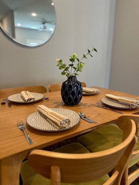 a table with plates and a vase with a plant