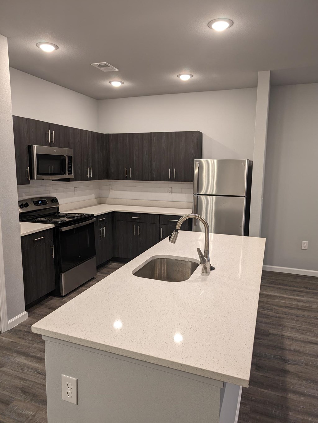 a kitchen with a sink and a refrigerator