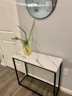 a small table with a vase on top of it