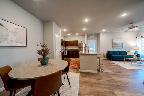 a dining room with a table and chairs and a living room