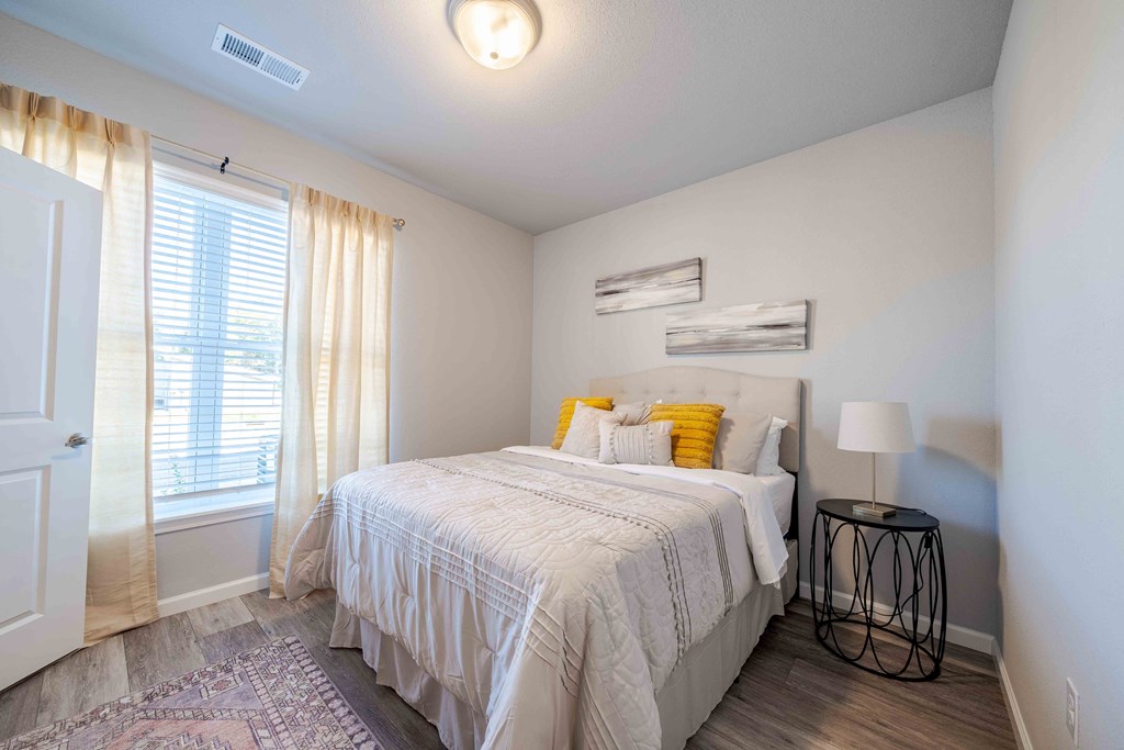 a bedroom with a bed and a window