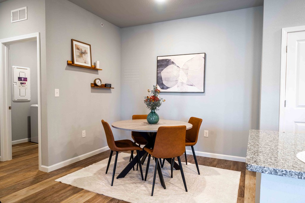 a dining room with a table and chairs