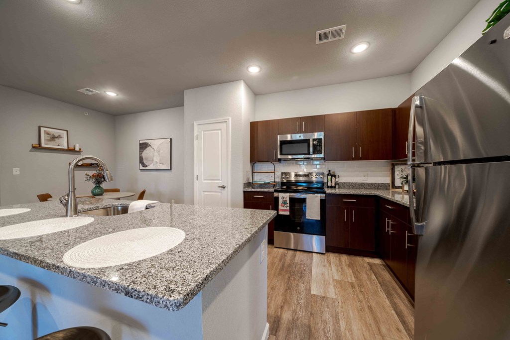 a kitchen with stainless steel appliances and granite counter tops