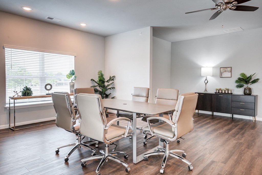 a conference room with a table and chairs