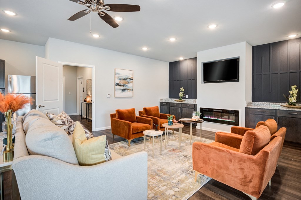 a living room with couches and chairs and a fireplace