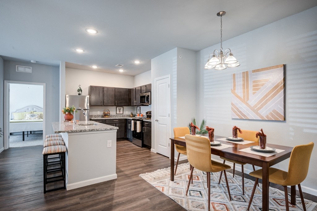an open kitchen and dining room with a table and chairs