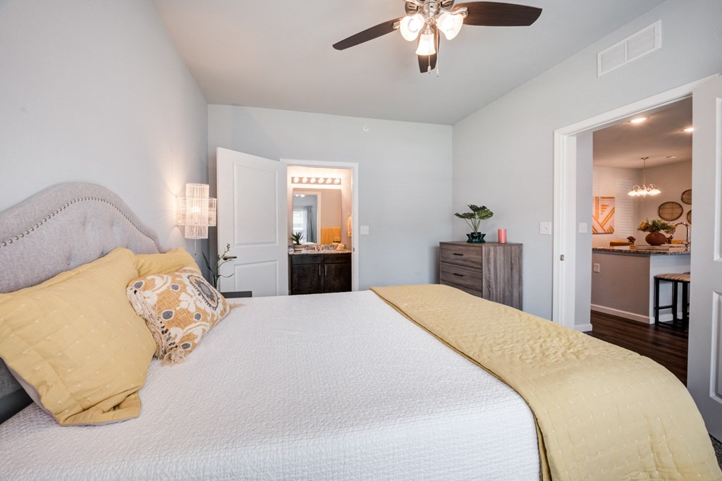 a bedroom with a large bed and a ceiling fan