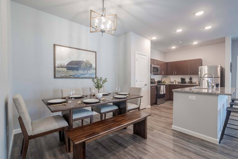 A modern kitchen with a dining table set for four.