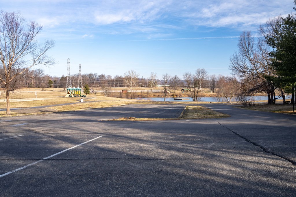 A large open parking lot with a clear blue sky above.