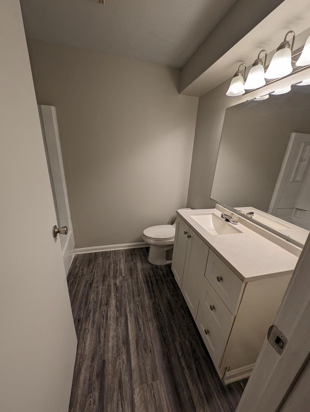 a bathroom with a toilet and a sink and a mirror