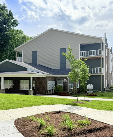 A modern two-story building with a balcony on the upper floor.